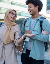 one woman with a hijab, a black man, and a white woman walk 