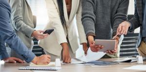 Adults at a conference table working together